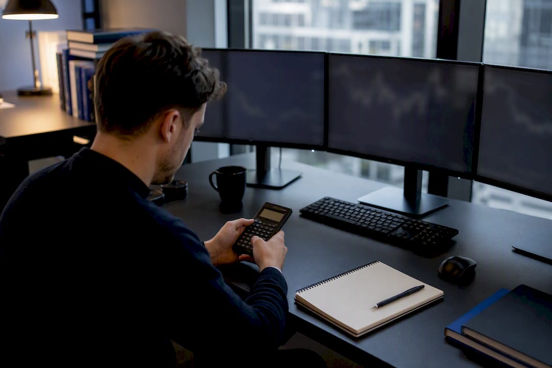 Trader’s hands analyzing forex volume data at desk